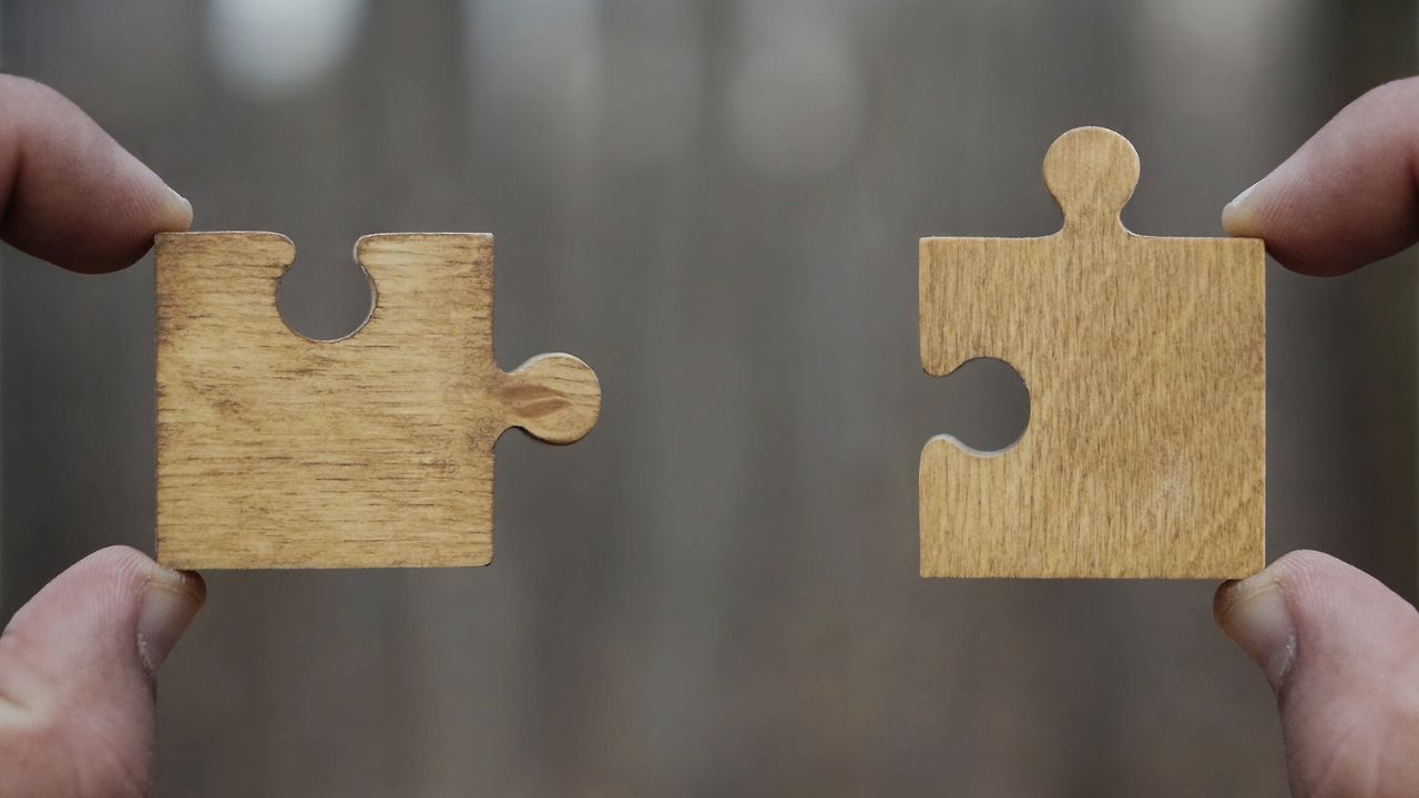 two puzzle pieces that appear to be a perfect fit
