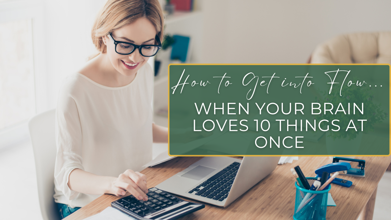 A multipassionate at a desk with multiple projects layered around them — notebooks, laptop, art supplies — illustrating structured, layered focus and creative flow.