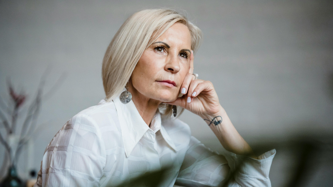 Thoughtful woman in her 50s reflecting on starting over and building confidence with money at any age
