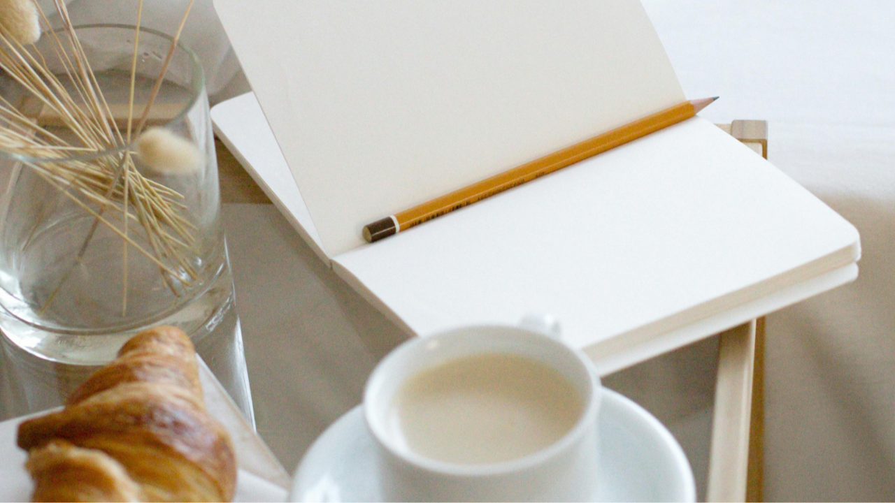 Soft Sunday morning journaling ritual with coffee and notebook for financial reflection
