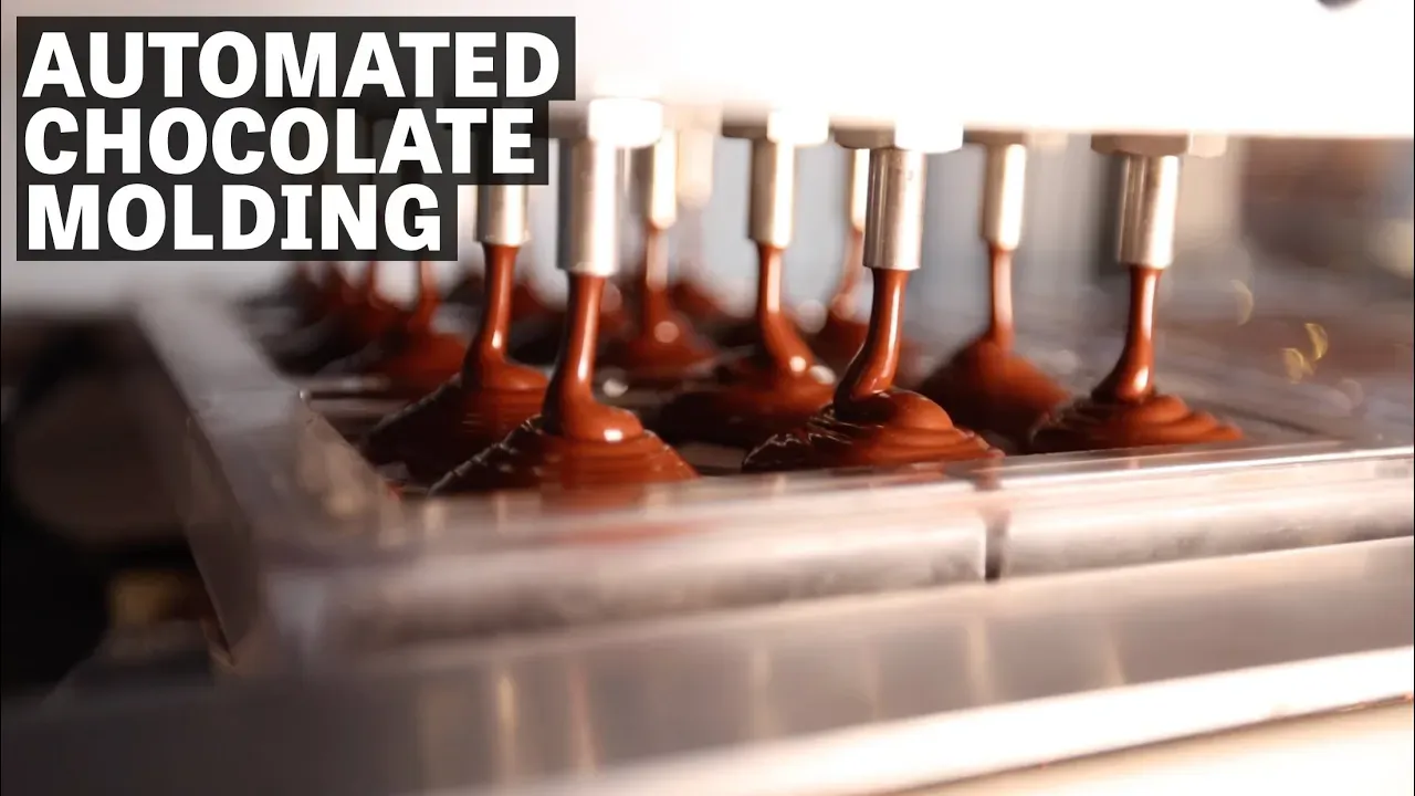 Image of automated chocolate molding with text reading "Automated Chocolate Molding". 
