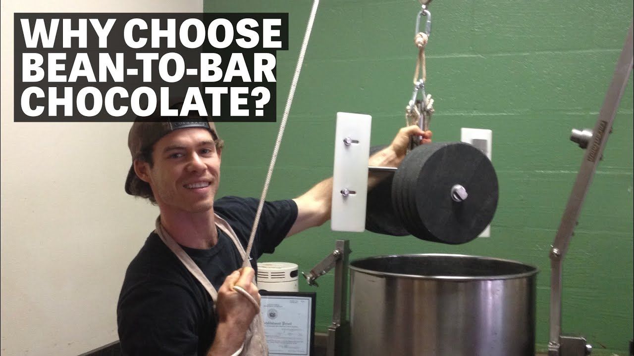 Image of a person holding stone wheels from chocolate grinder with text reading "Why Choose Bean To Bar Chocolate?"