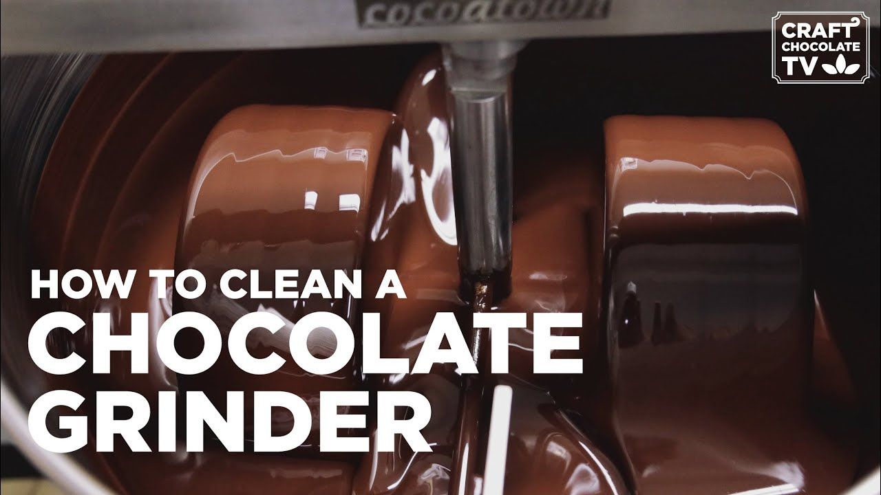 Image of a chocolate inside a stone grinder with the text "How to clean a chocolate Grinder".