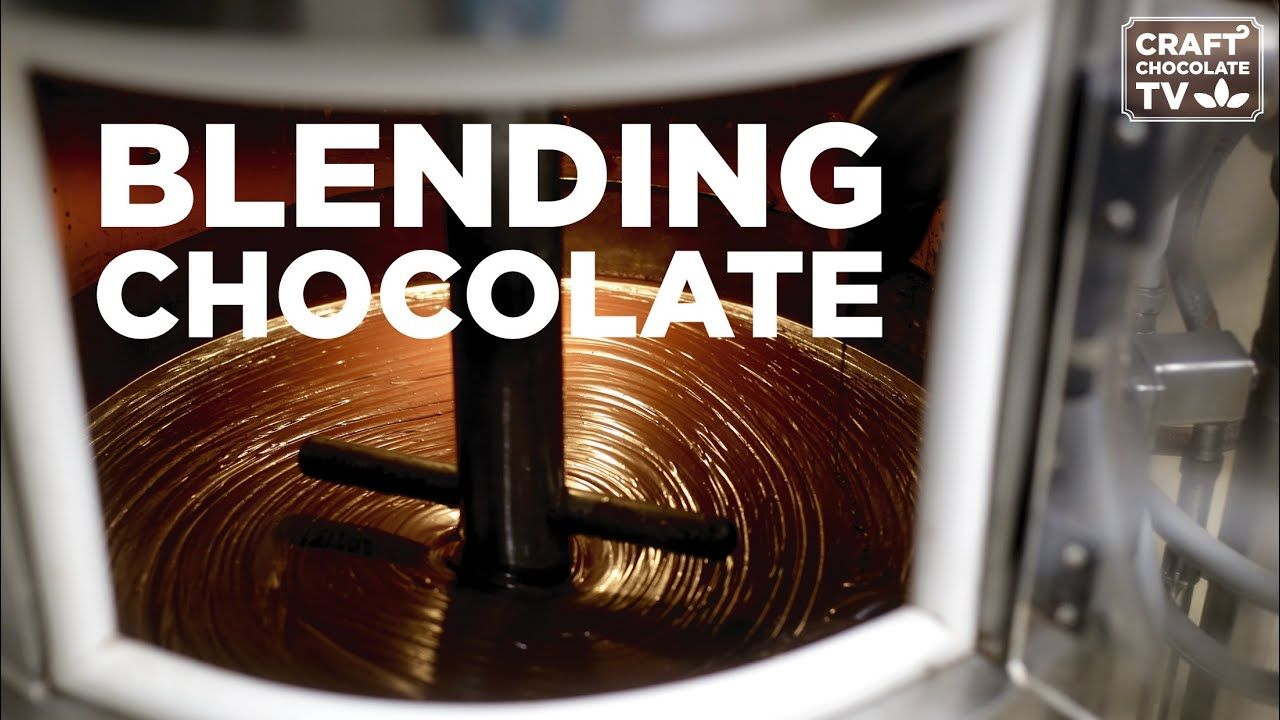 Image of  chocolate in a stone grinder with the text "Blending chocolate". 