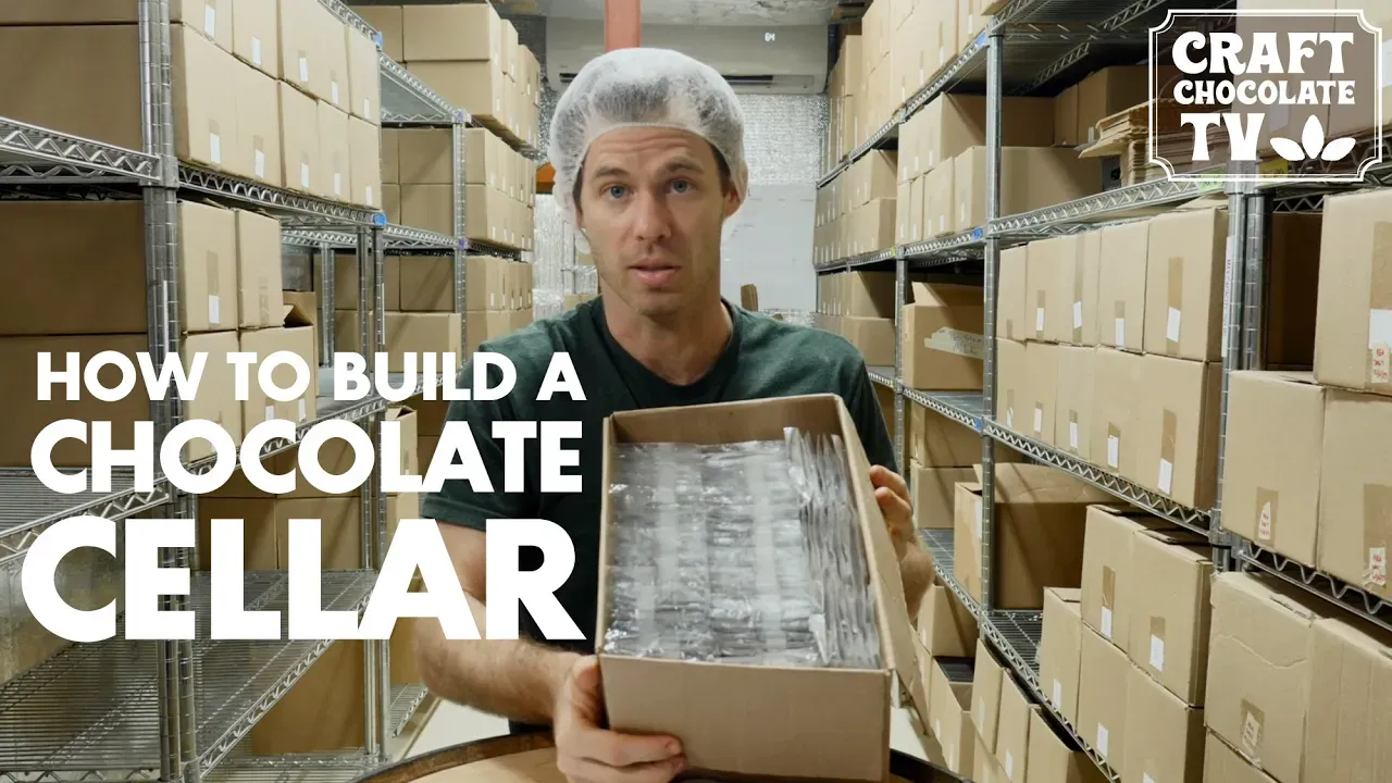 Image of a person holding a box in a chocolate cellar with text reading "How To Build A Chocolate Cellar". 
