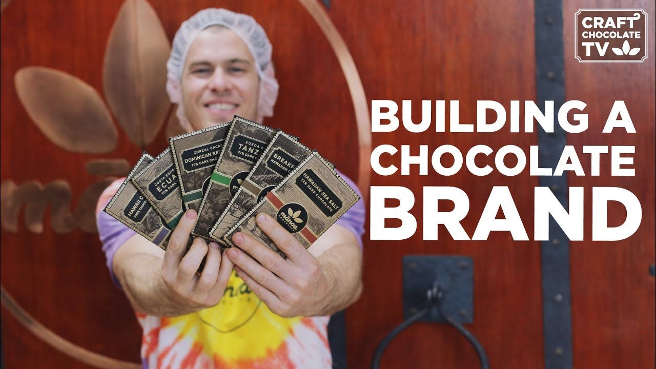 Image of a person holding chocolate bars with the text "Building a chocolate brand".