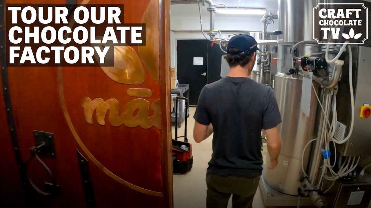Image of a person walking in a chocolate factory with text reading "Tour Our Chocolate Factory". 