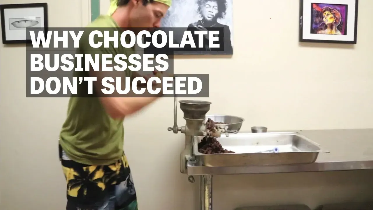 Image of man grinding cacao with hand grinder with text reading "Why Chocolate Businesses Don't Succeed". 