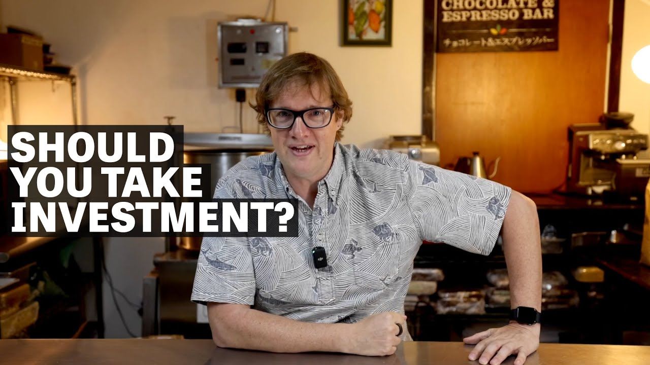 Image of a man sitting at table with text reading "Should You Take Investment?".