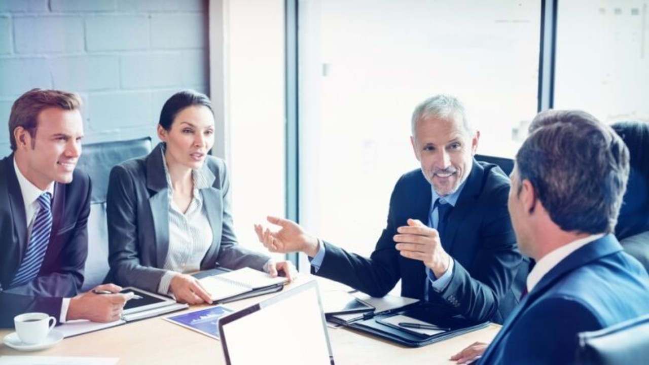Executive board meeting discussing artificial intelligence strategy, governance, and decision intelligence in a modern corporate boardroom