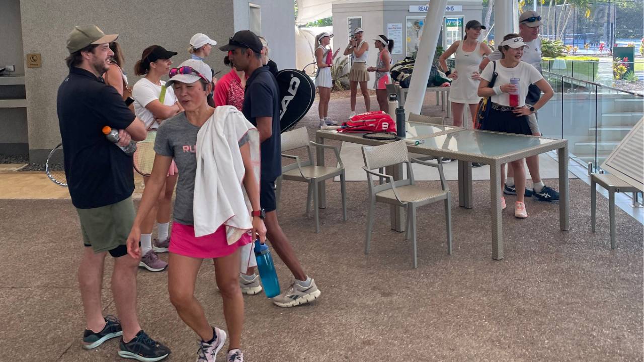 Players relaxing and chatting after a Ready for Tennis adult event at RACV Royal Pines, showcasing the social and community atmosphere.