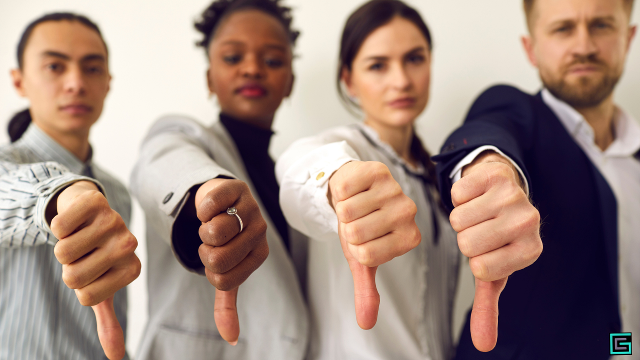 A group of directors showing thumbs down to signal disagreement