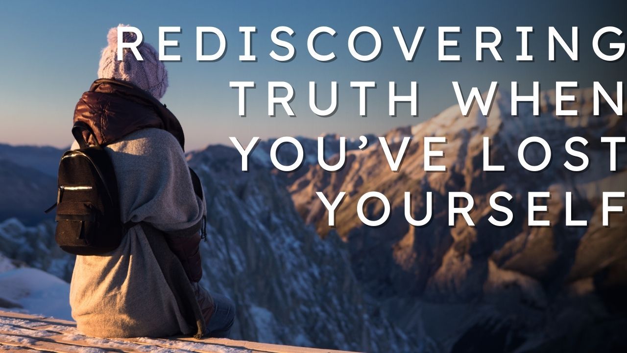 Woman with a backpack looking over the mountains  