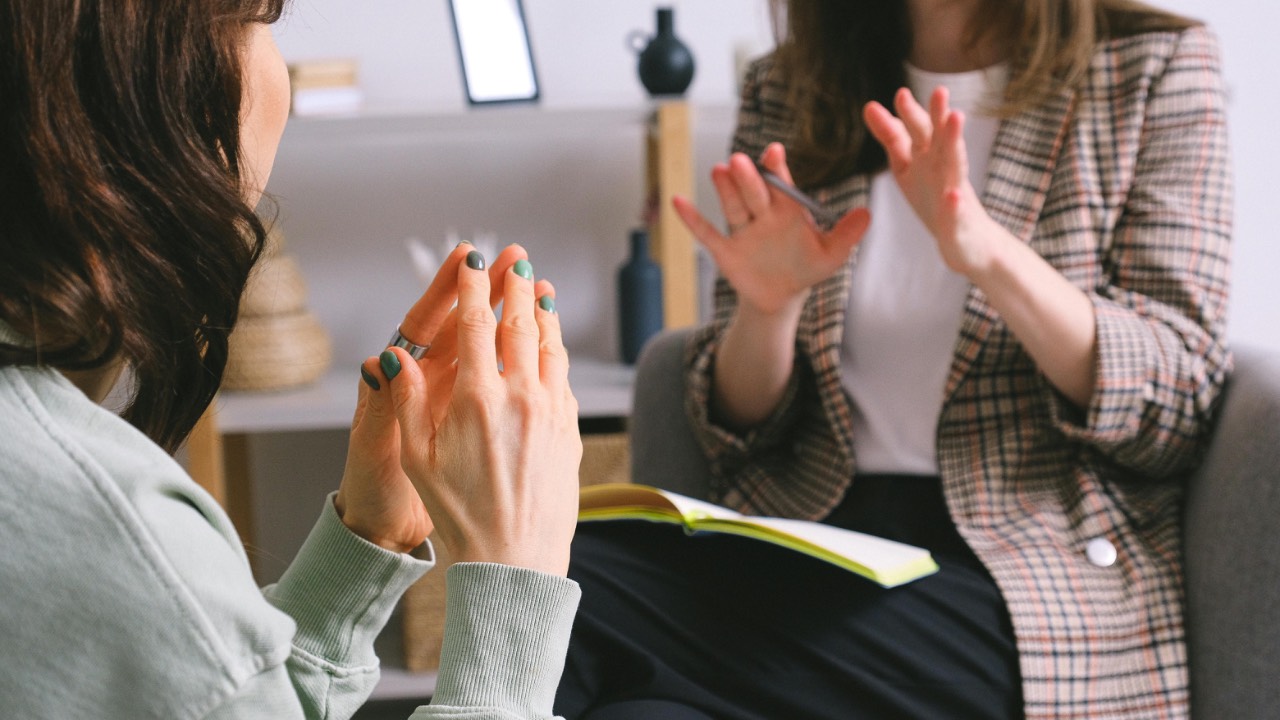 Therapist speaking to therapy group client