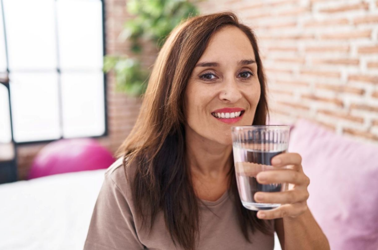Woman smiling with water glass