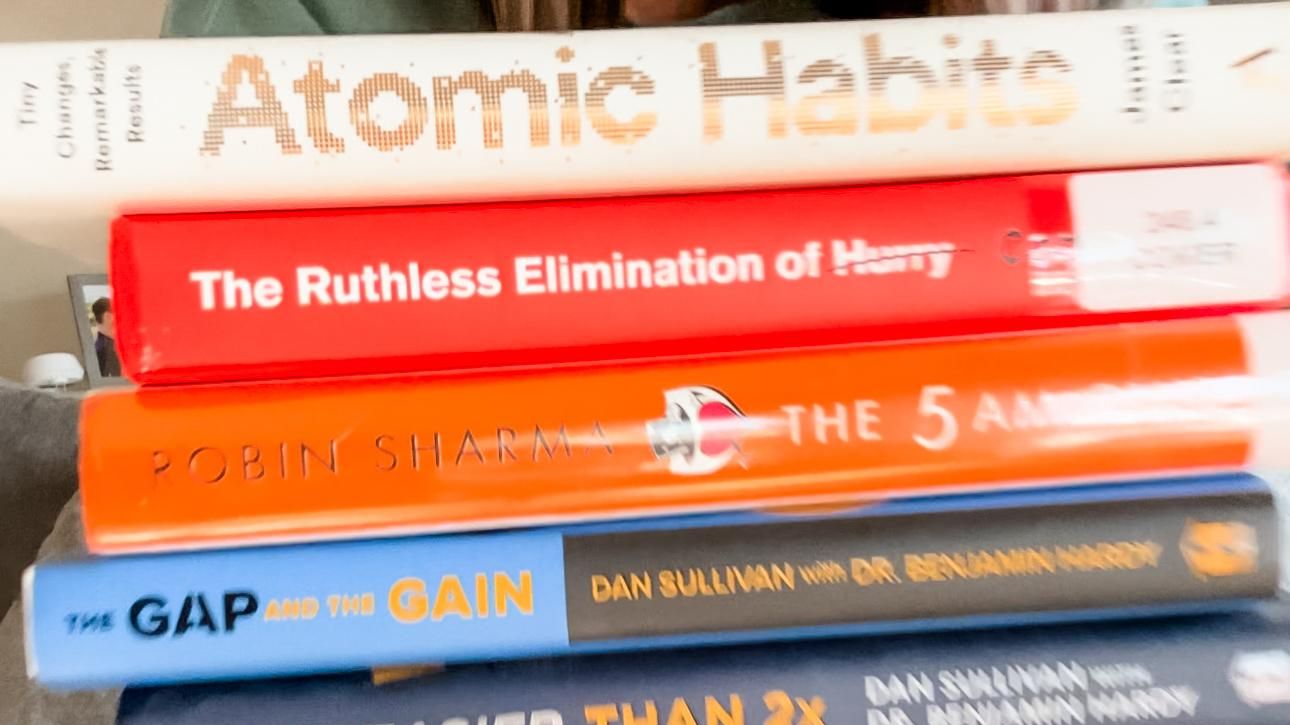 woman-holding-stack-of-personal-growth-books