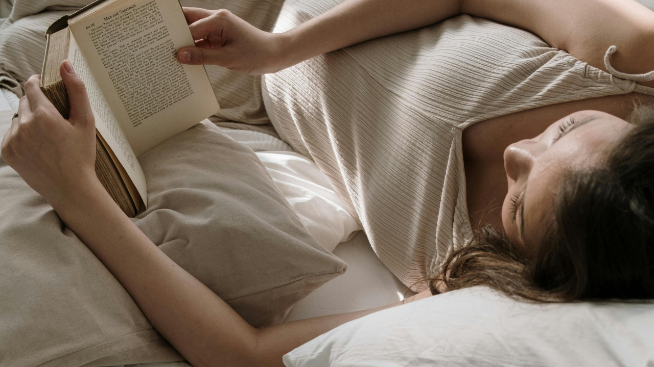 mother-lying-on-bed-reading-a-book
