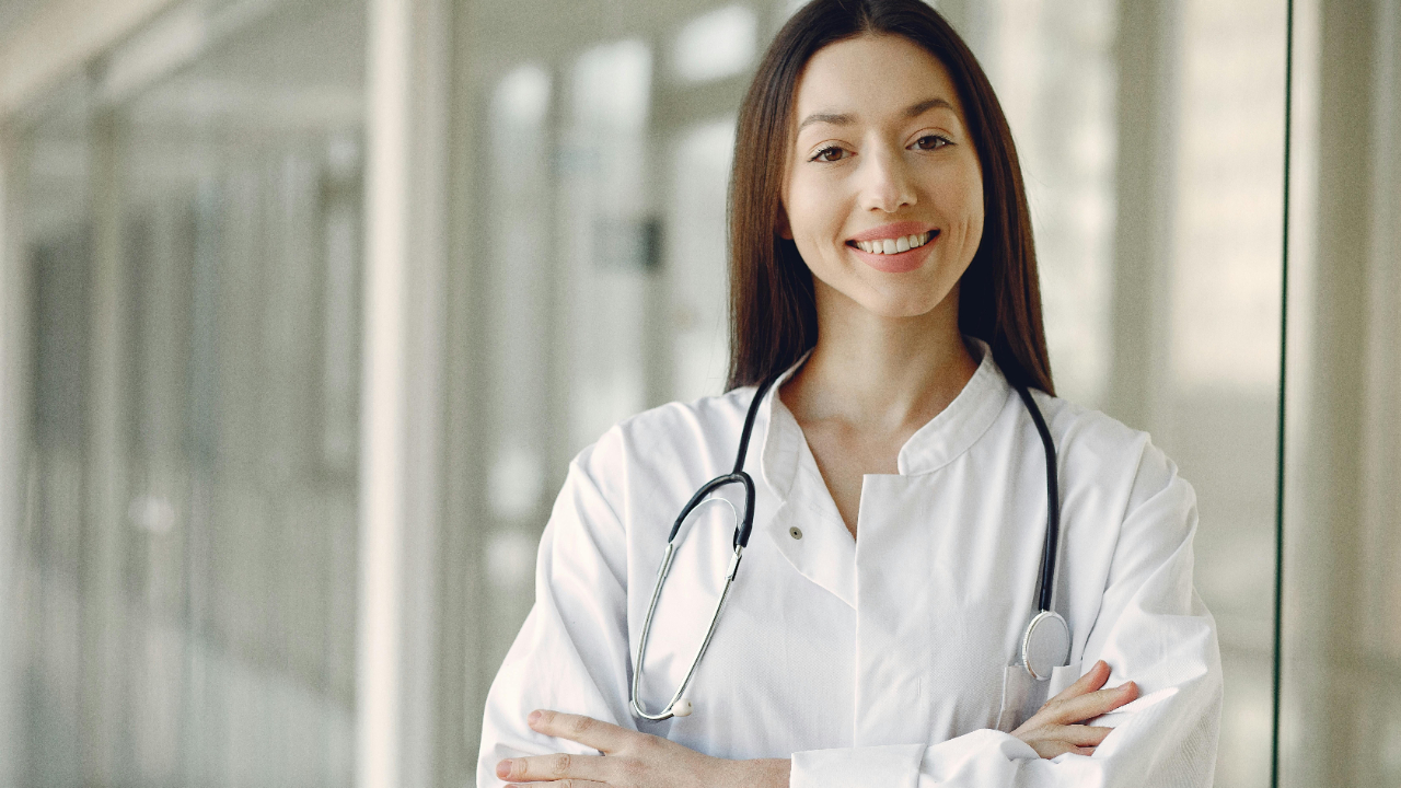 doctors in white scrubs smiling at the camera