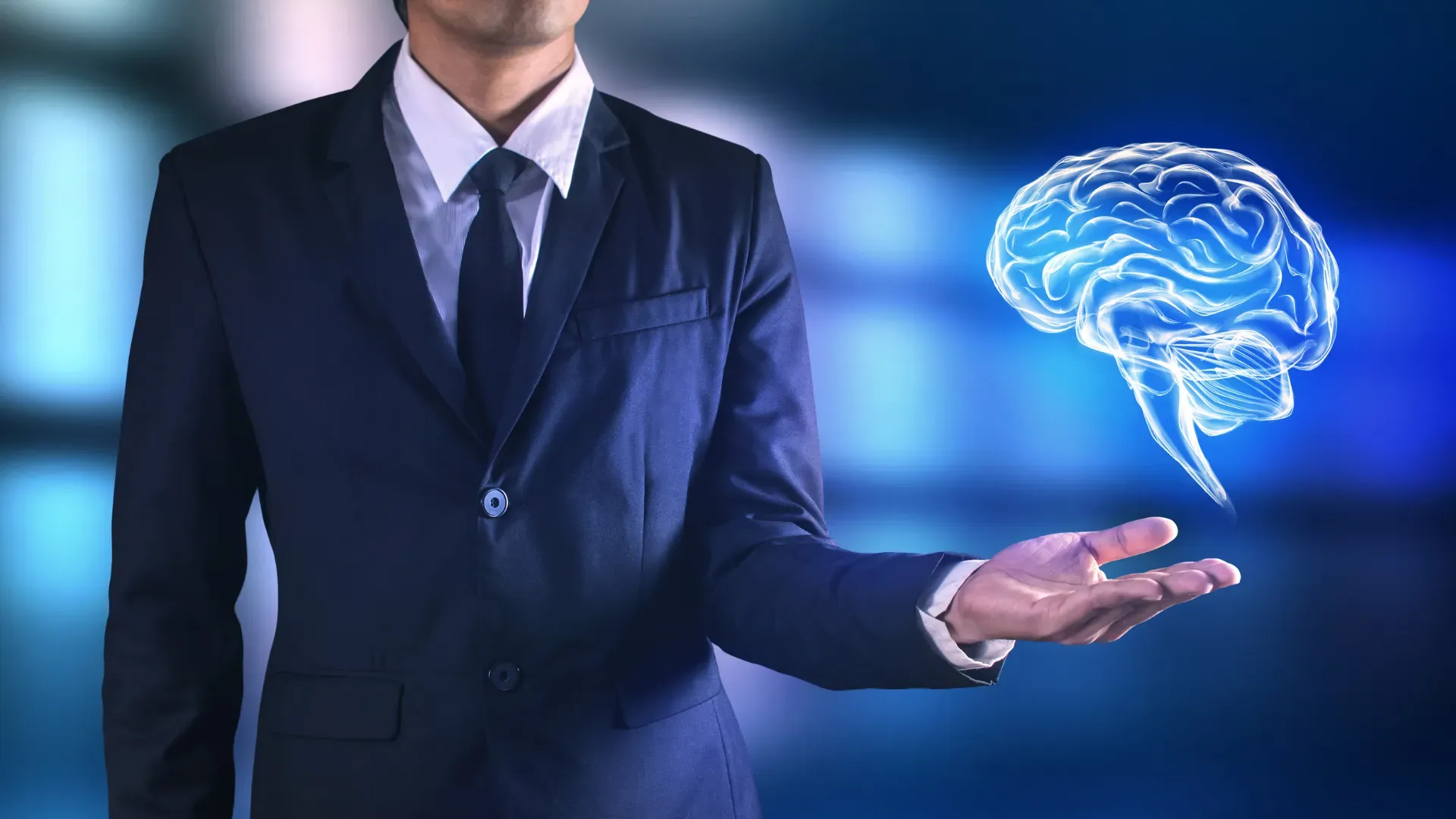 Professional holding a digital brain symbolizing neuroscience courses and brain-based performance training