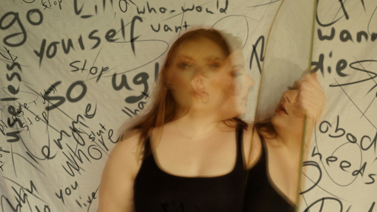 Person looking in the mirror with self-doubt