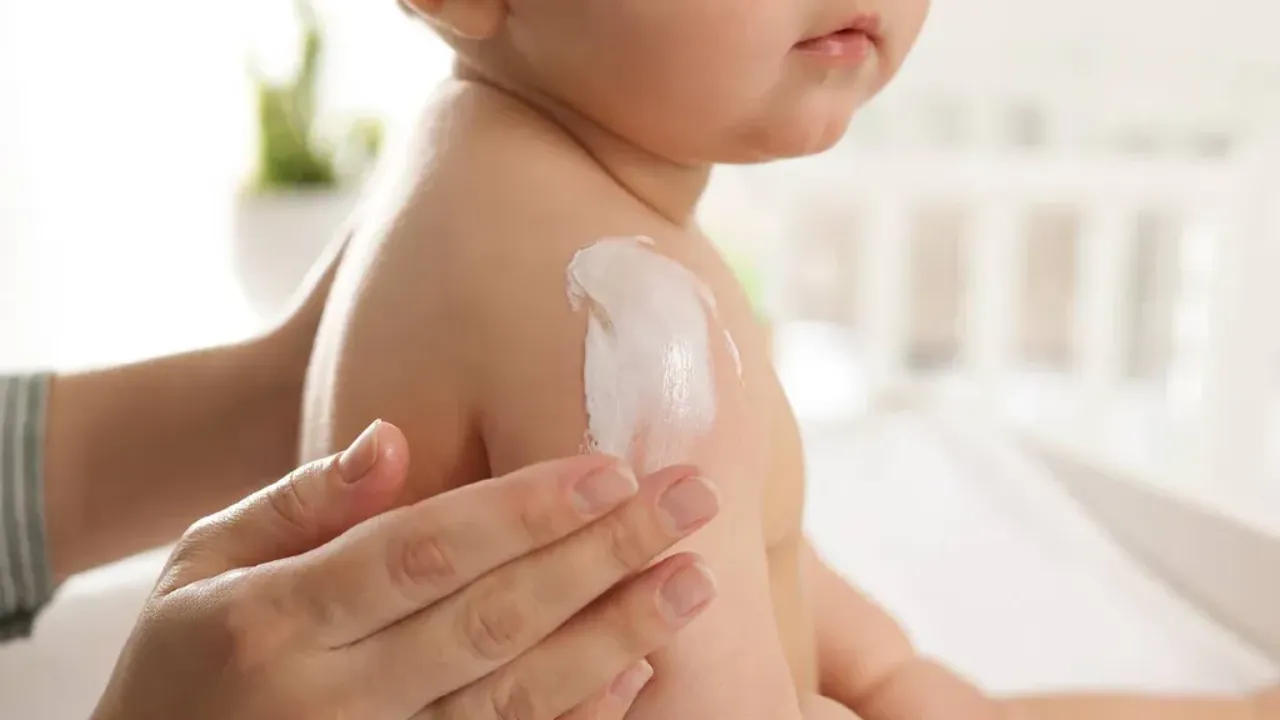 Parent's had applying cream on baby skin