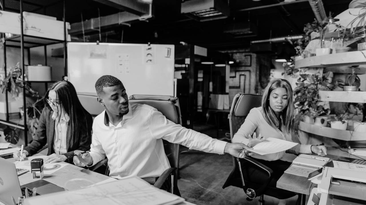 Coworkers passing documents, leadership, empathy