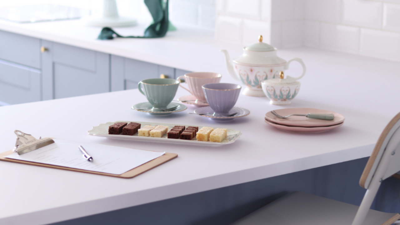 Cake consultation order form on clipboard next to wedding cake tasting samples illustrating a structured cake enquiry process for cake designers.