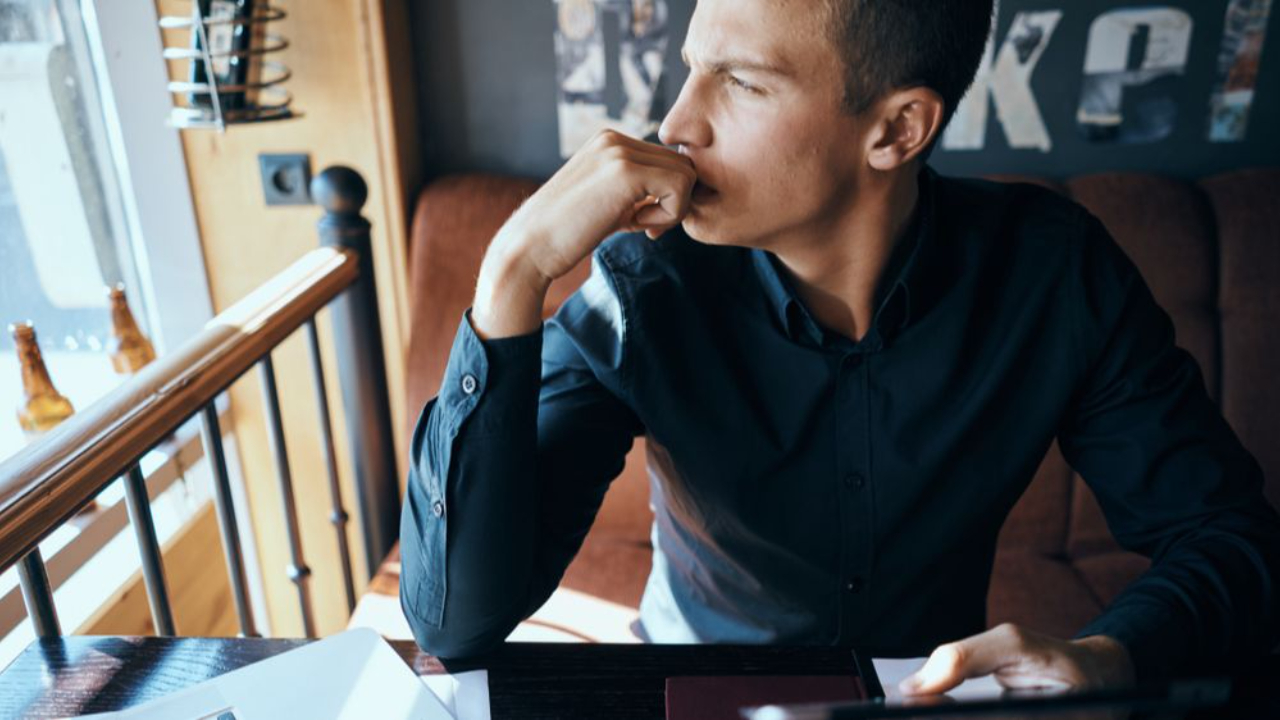 Man preparing notes on a laptop before a last minute presentation or interview