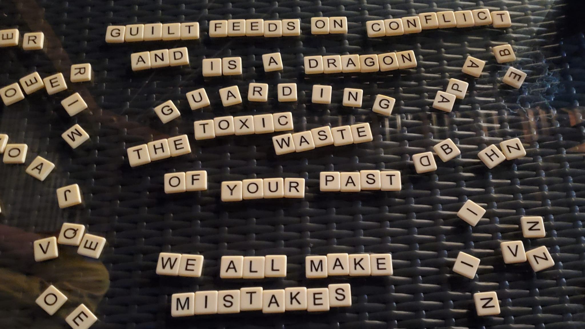 Runes that spell out: "Guilt feeds on conflict and is a dragon feeing on the toxic waste of your past; we all make mistakes"