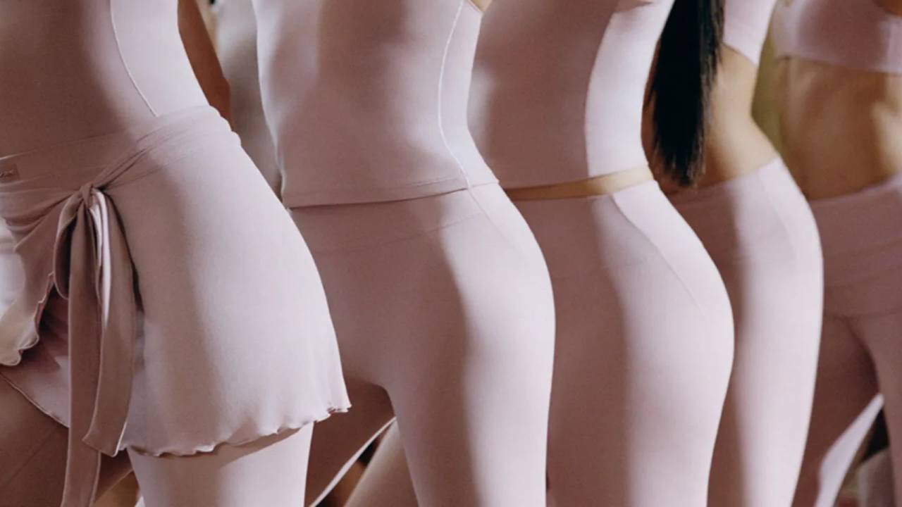 line of womens hips all wearing light pink workout wear