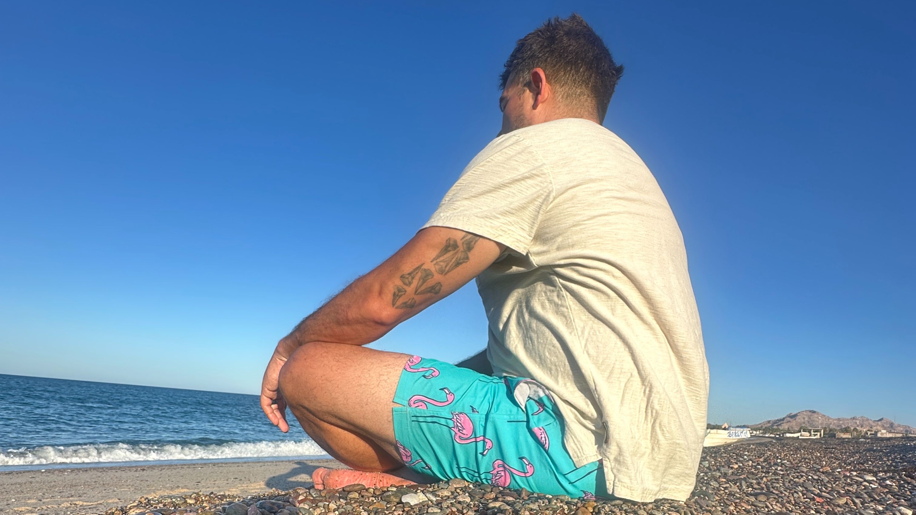 Photo of a man meditating on a beach in Mexico