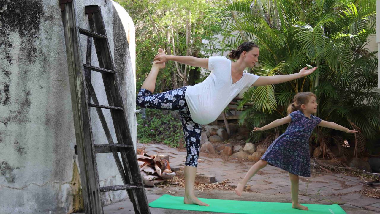 Photograph of prenatal yoga teacher with older children in tow