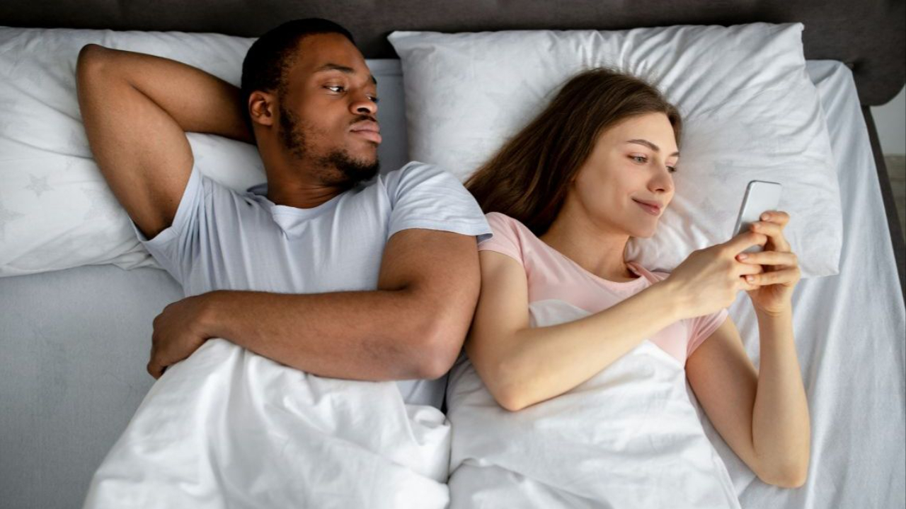 man and woman in bed