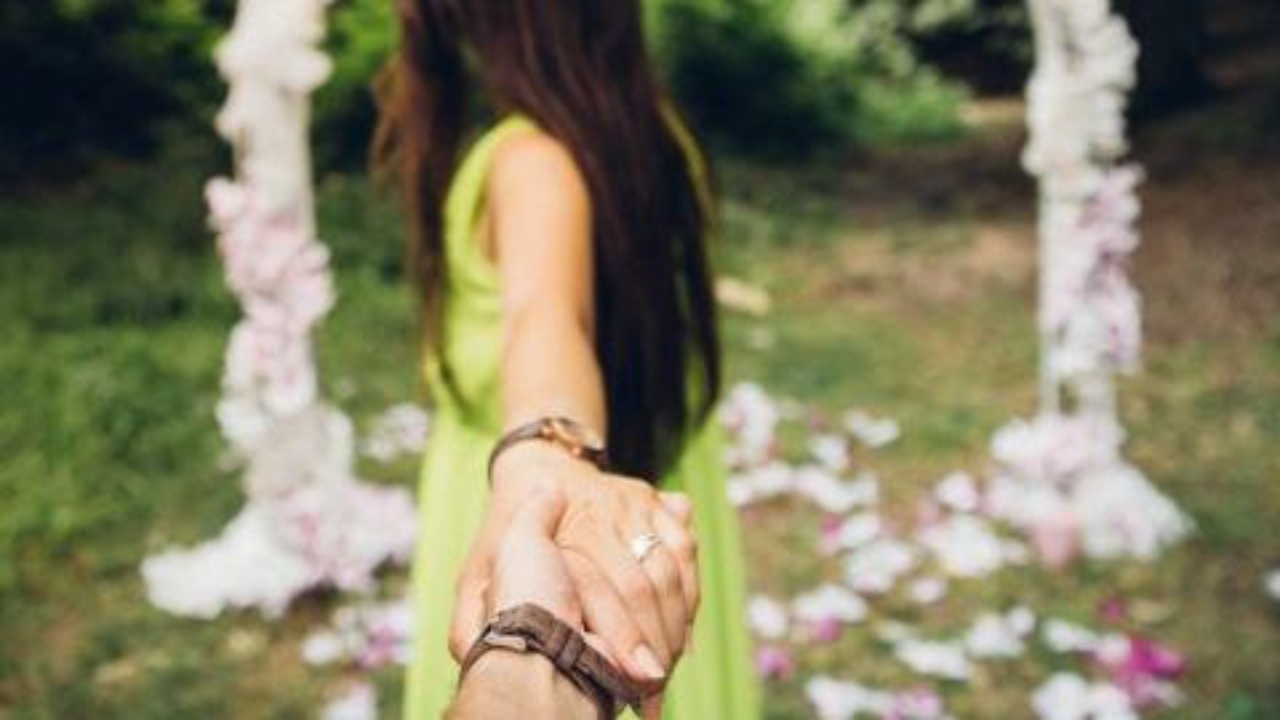 Woman leaving mans hand