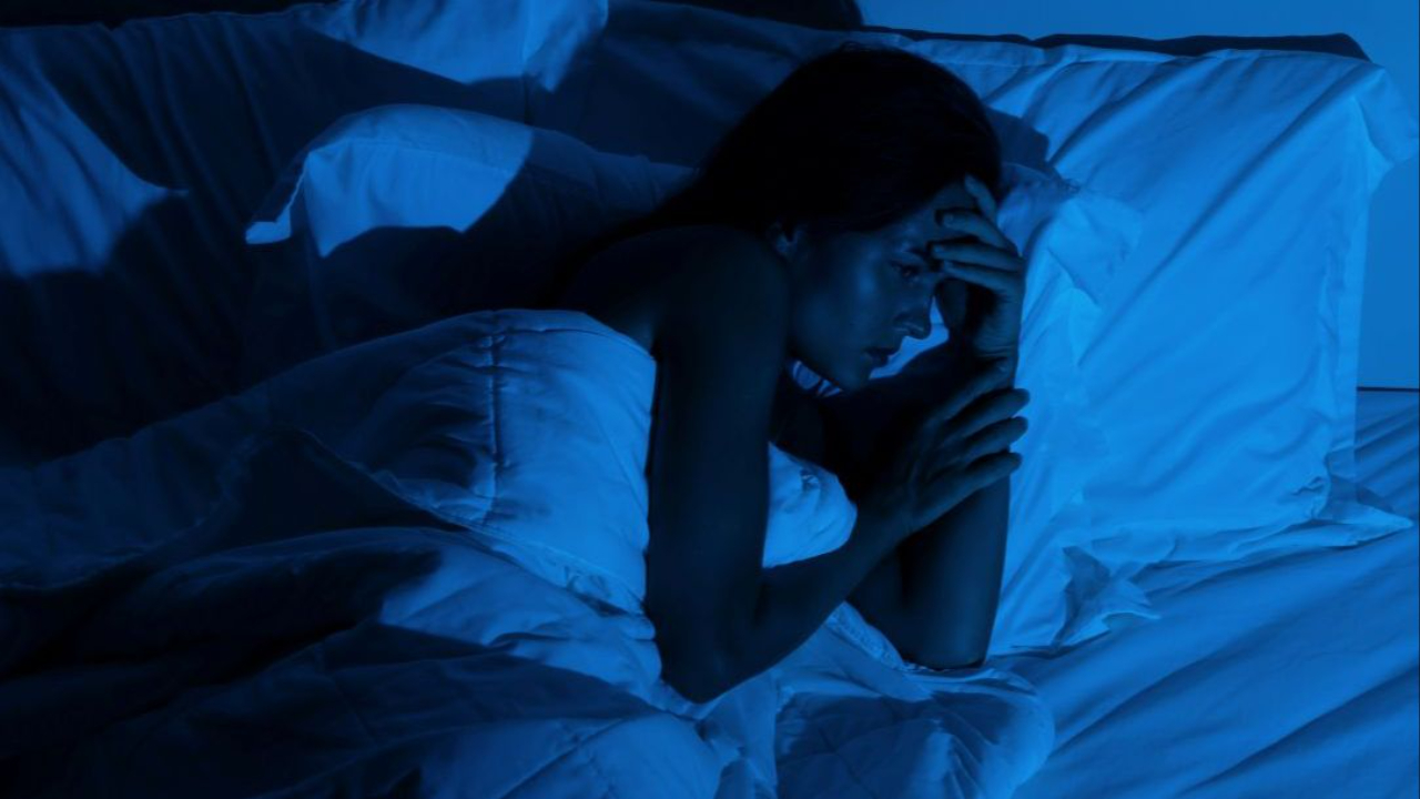 woman in bed insomnia