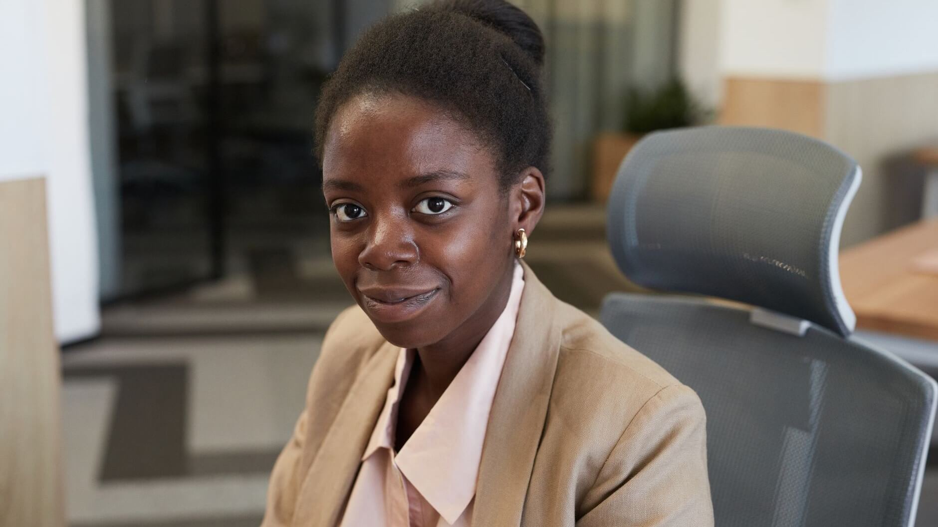 a sitting woman smiling at the camera