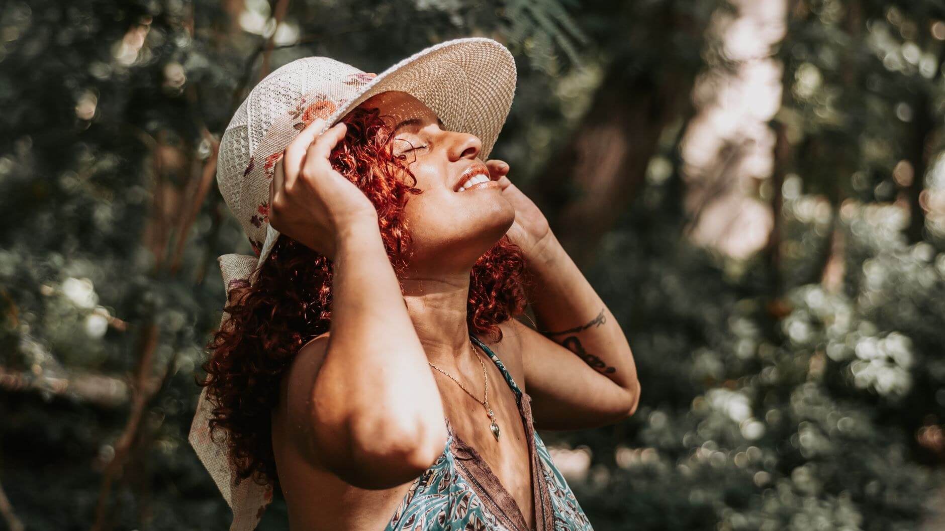 a woman facing the sun outside