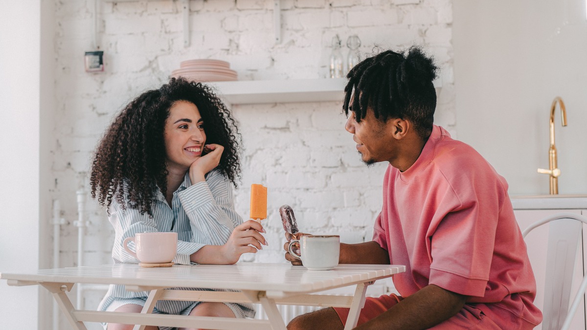Couple discussing everyday responsibilities together over coffee