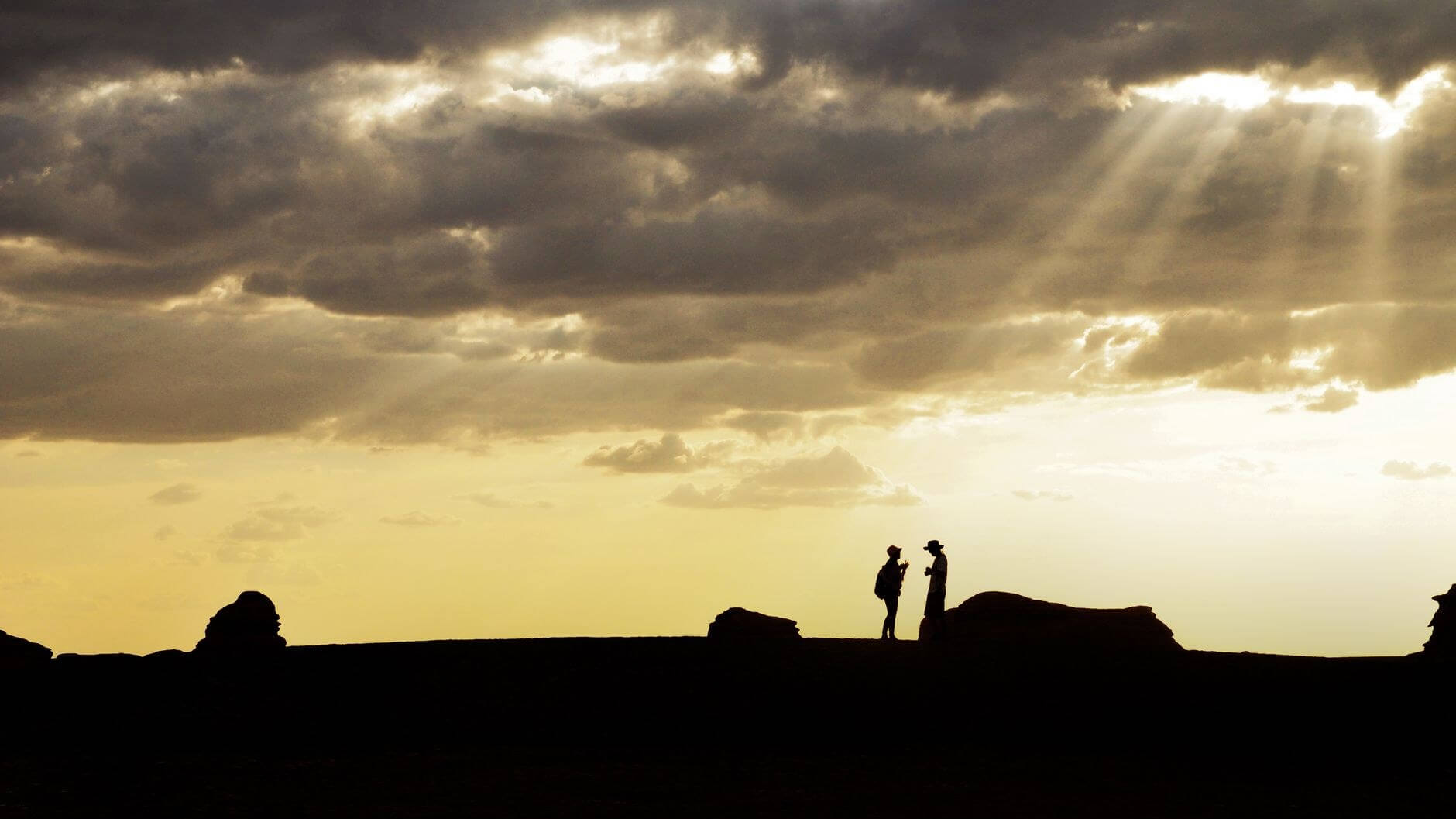 silhoutte of two people from afar