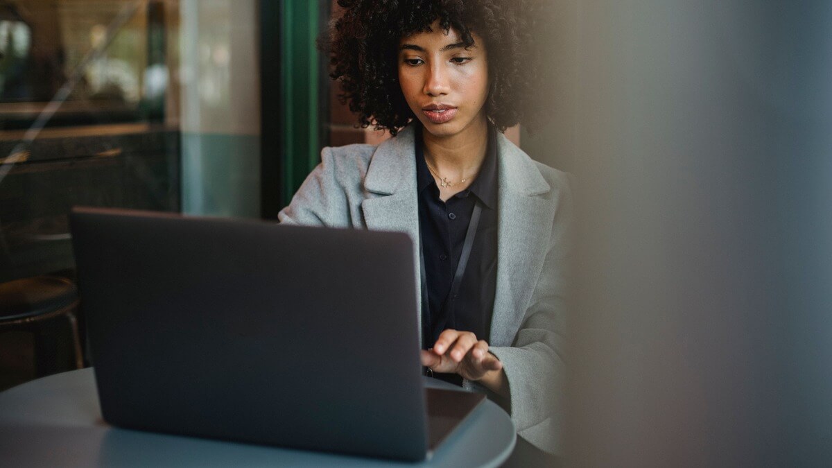 a woman looking at her laptop