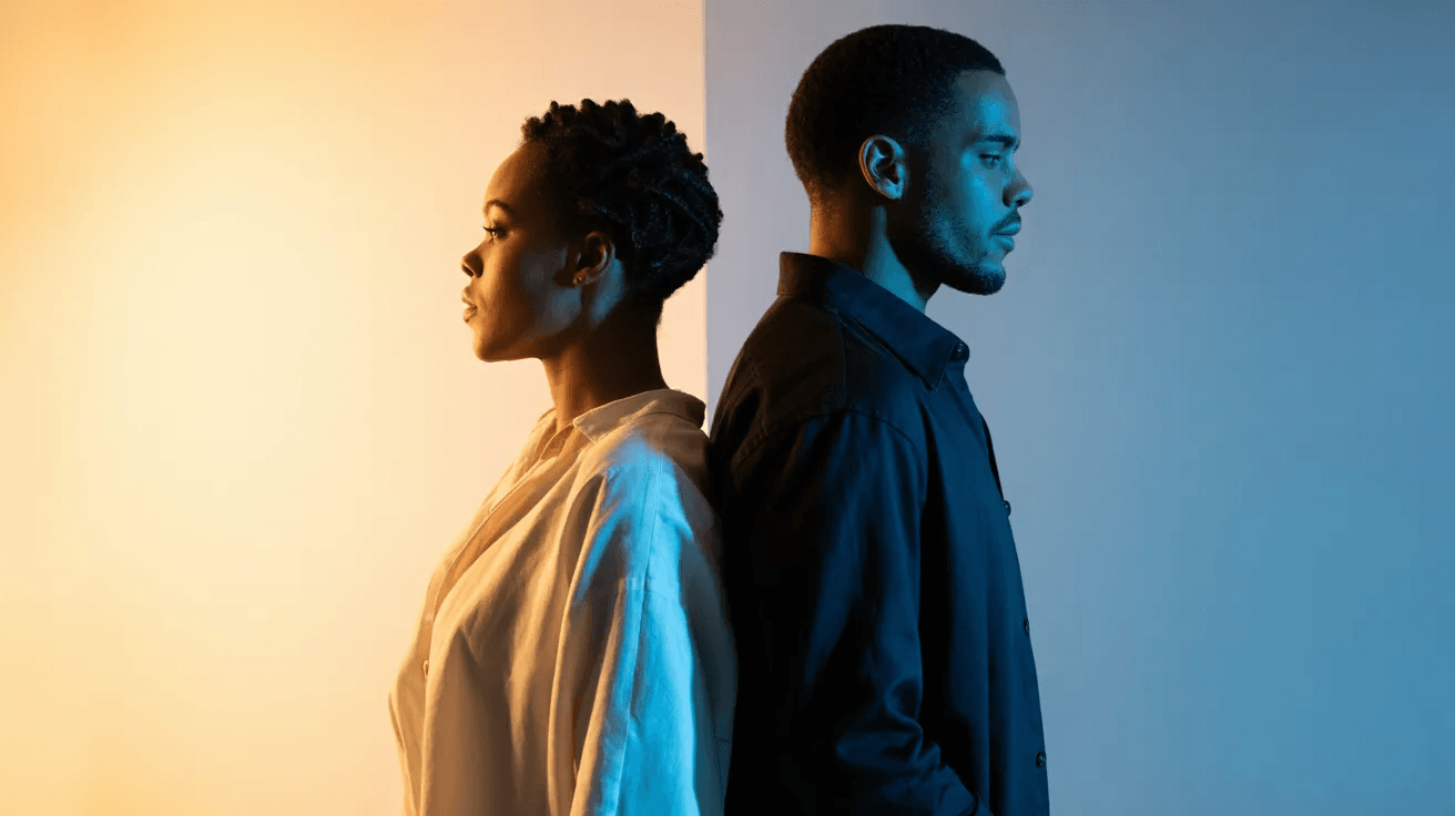 image of a couple standing back to back, the woman against a yellow background while the man in blue background 
