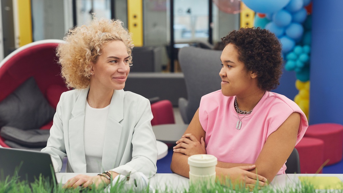 Two women talking together, representing common questions about money mindset courses