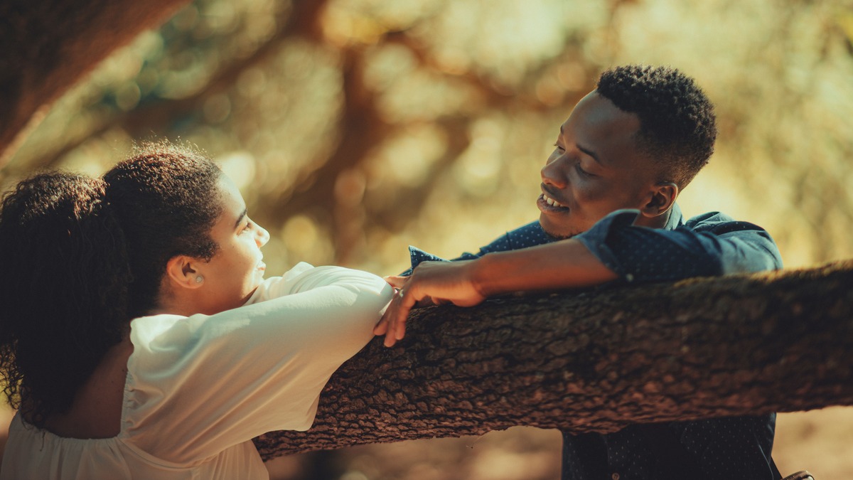 Couple smiling together outdoors, illustrating attraction and closeness in a long-term relationship