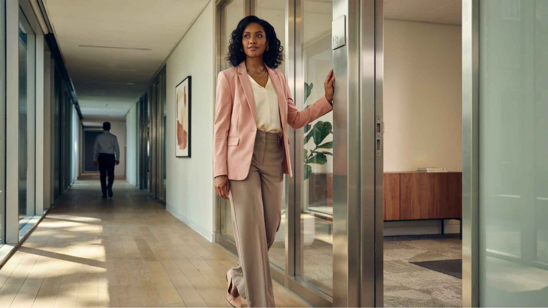 a woman standing in front of an office