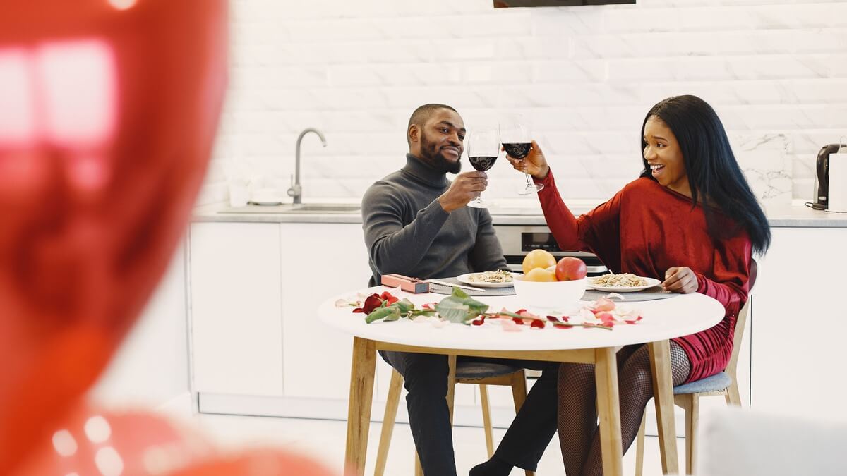 a man and woman clinking their wine glasses