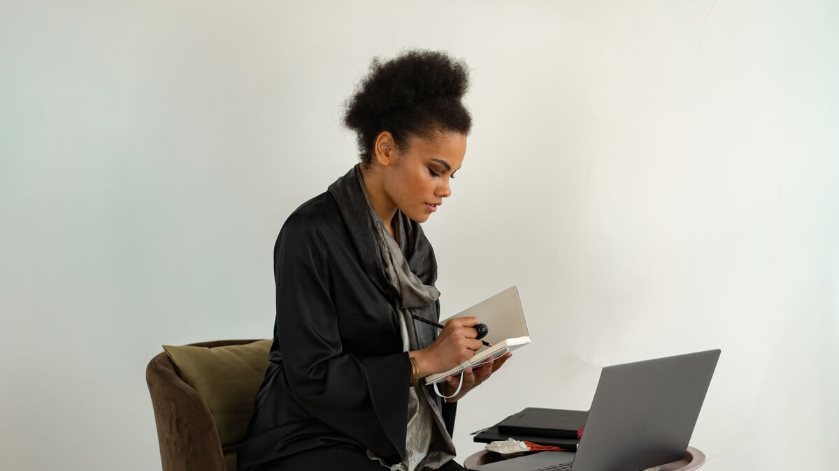 a woman working in front of a laptop