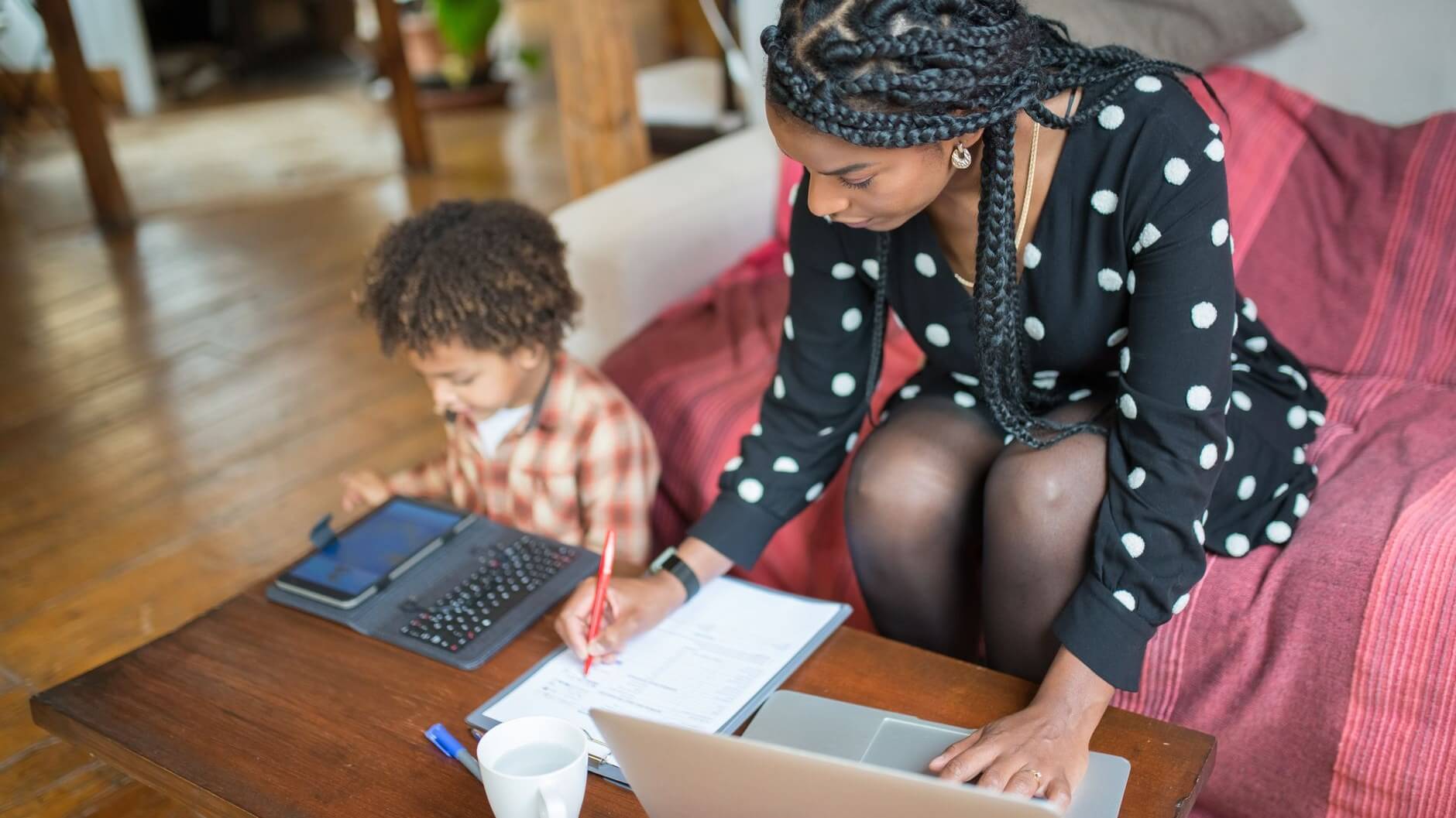 a woman working beside her child