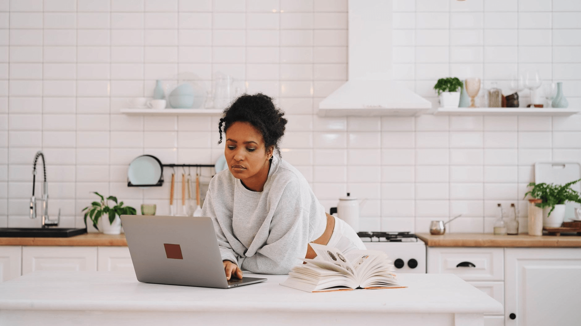 a woman working on her laptop in the kitchen island