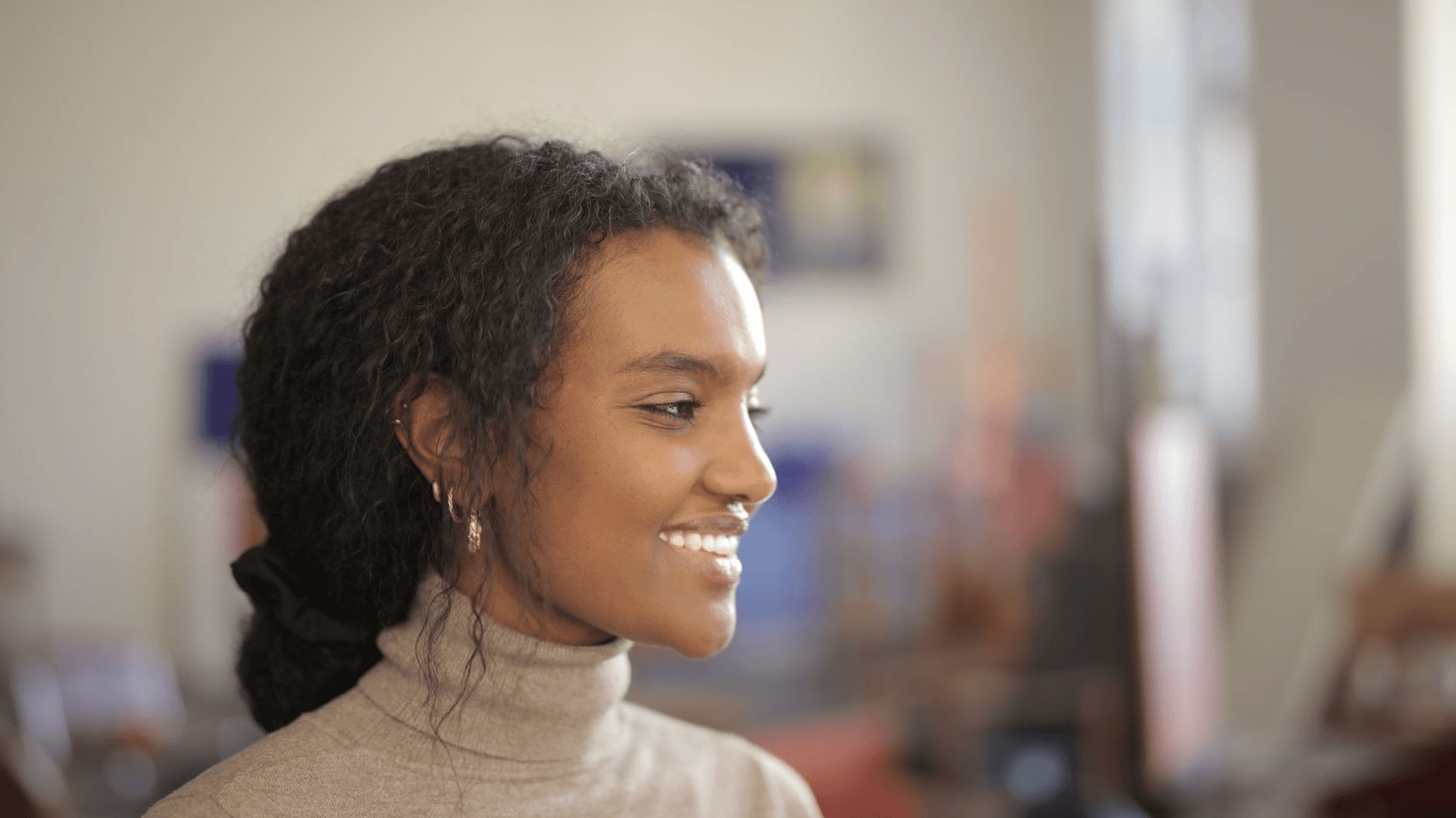 a woman smiling with her side profile