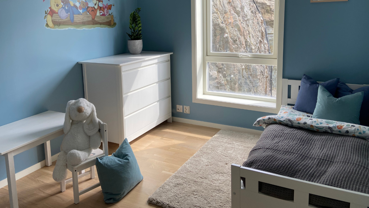 Et ryddig barnerom med blå vegger
